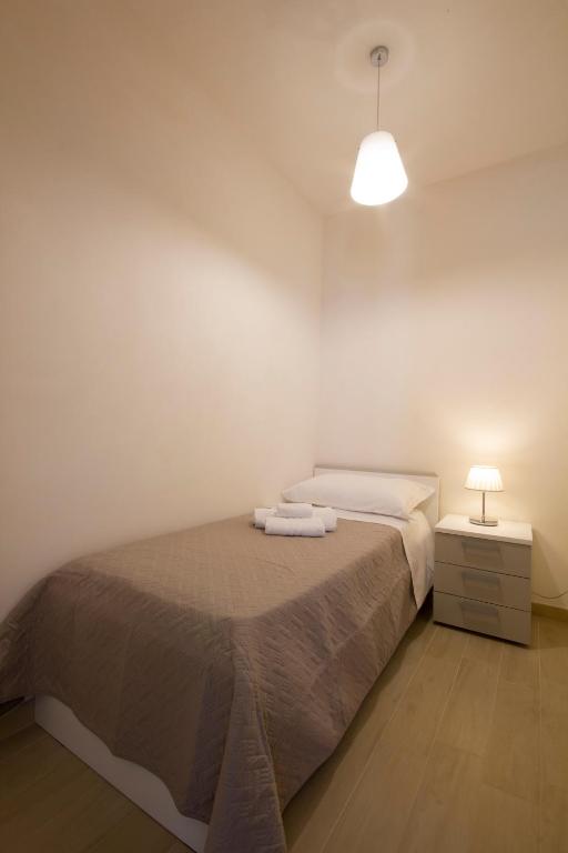 A bed or beds in a room at La Perla dello Stagnone