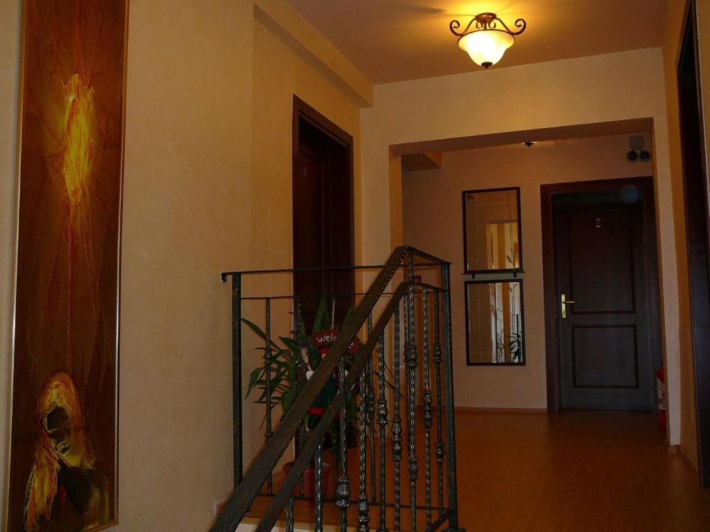 a room with a staircase and a hallway with a door at Casa iRMA - Rooms for rent in Bacău