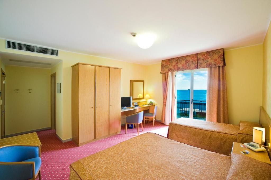 Postel nebo postele na pokoji v ubytování Hotel La Tonnara