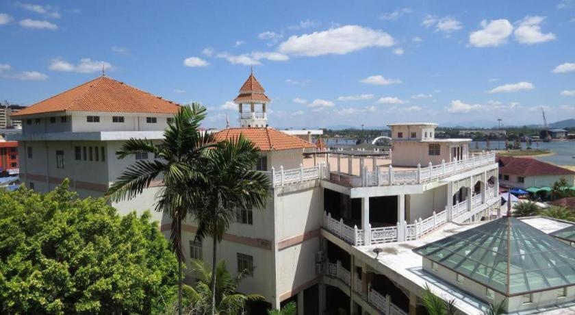 a building with a palm tree in front of it at THE ROOM @ KT HOTEL in Kuala Terengganu