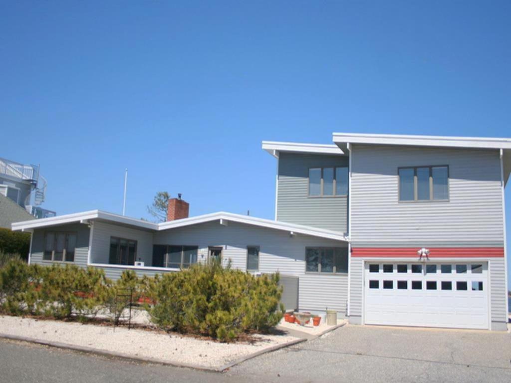 a large white house with a white garage at Bay Front Home In Loveladies, in Loveladies