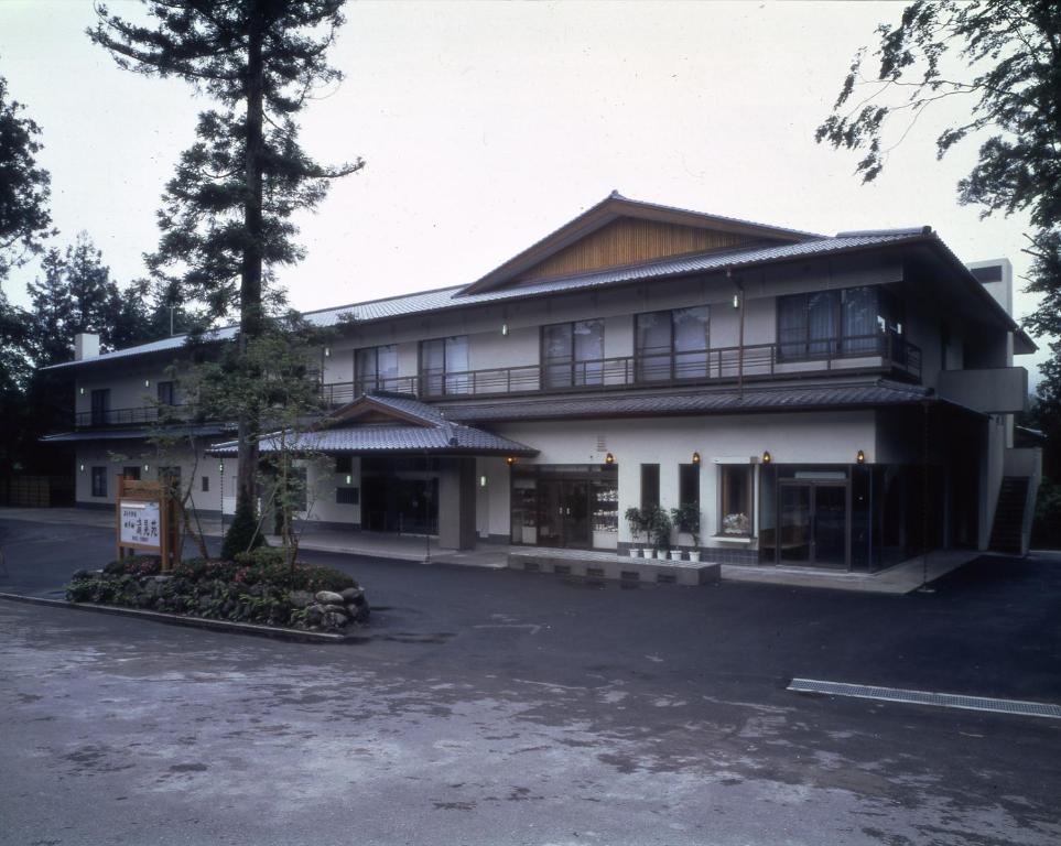 a building with a parking lot in front of it at Hotel Seikoen in Nikko