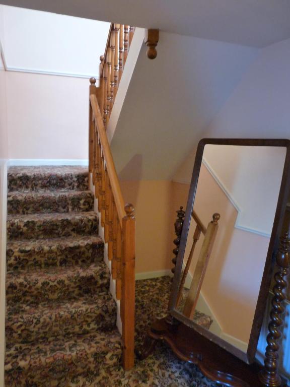 a stairway with a mirror next to a staircase at The Mill Bar in Athlone