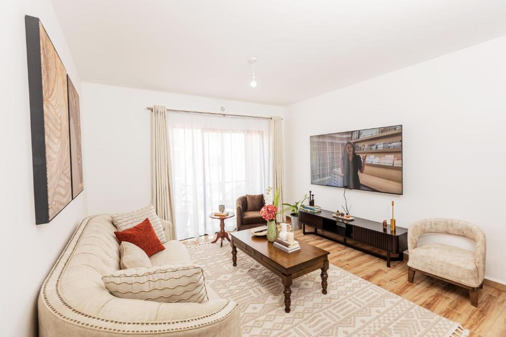 a living room with a couch and a table at SOFT LaNDING in Tatu City