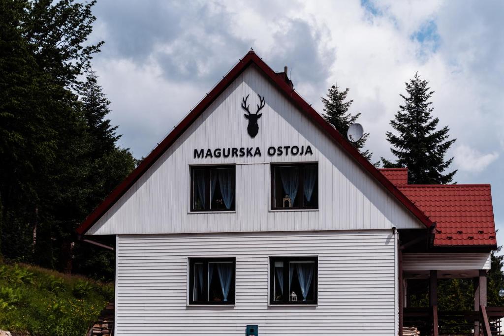 a large white house with a red roof at Magurska Ostoja in Jasło