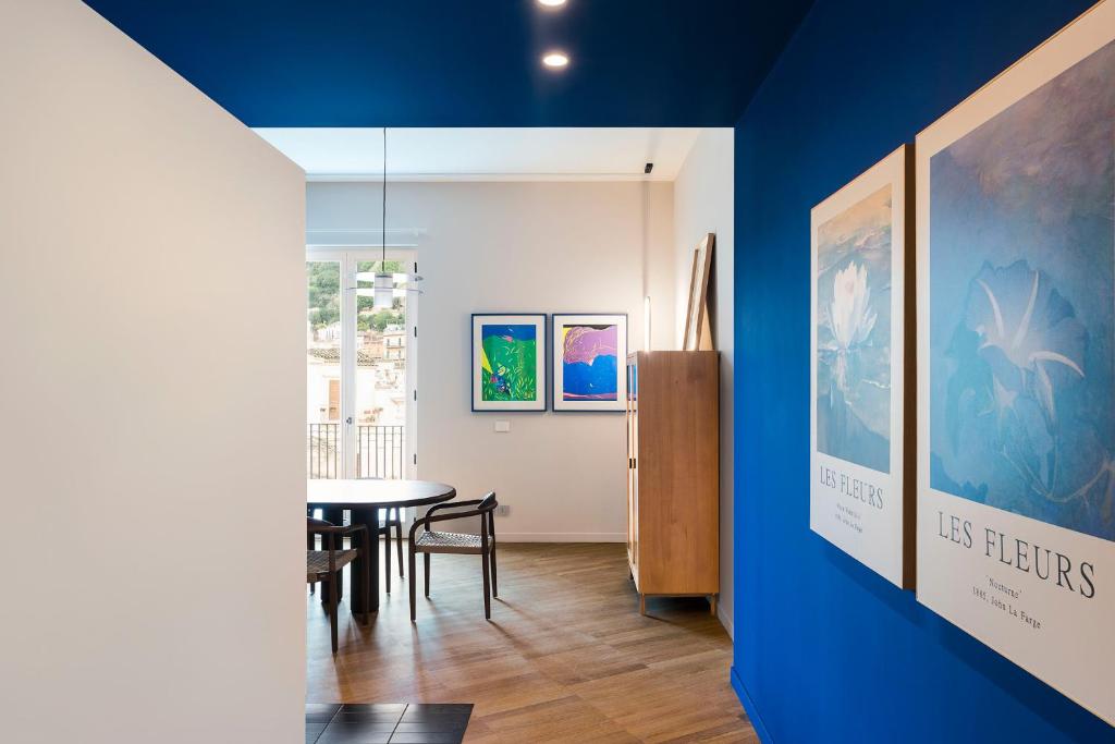 a room with a table and a blue wall at Al Monumento in Modica