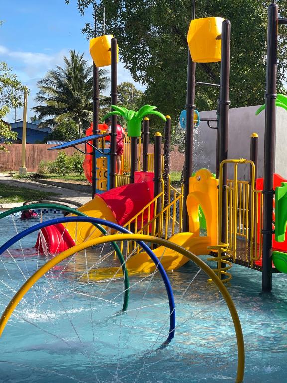 a water park with a colorful water slide at Sayong Resort in Kuala Kangsar