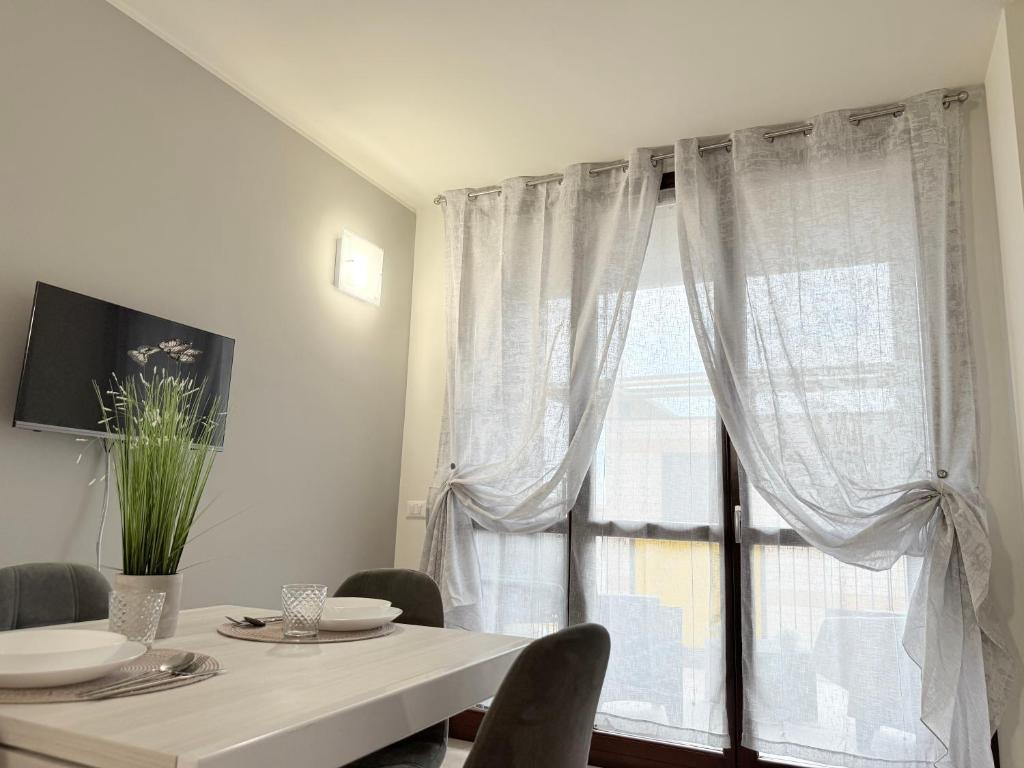 a dining room with a table and a large window at Deny & Carol's house - app. 33 in Somma Lombardo