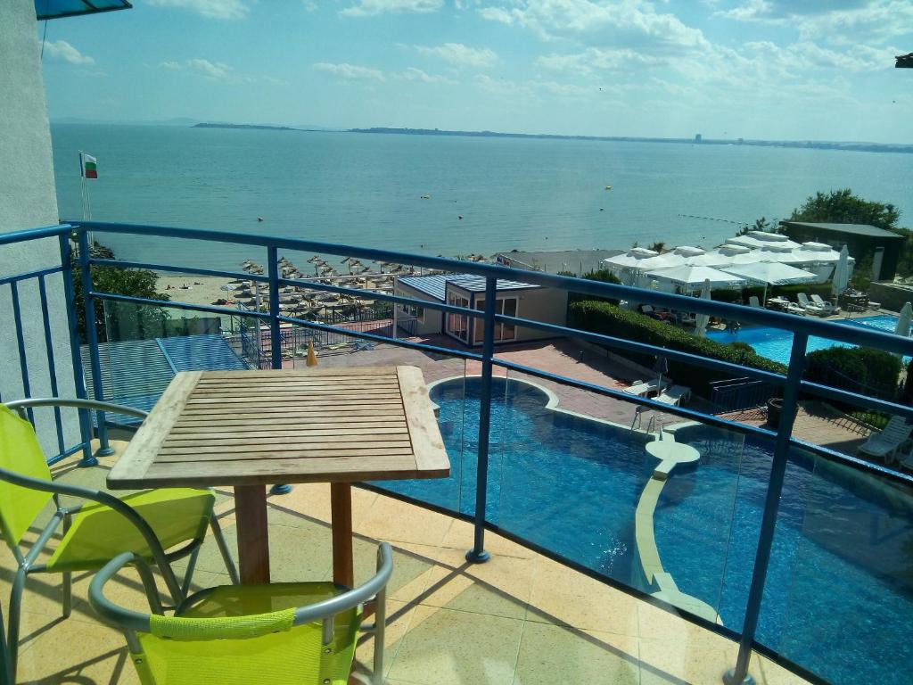 a balcony with a table and a view of the water at Vega Village Ap B39 in Sveti Vlas