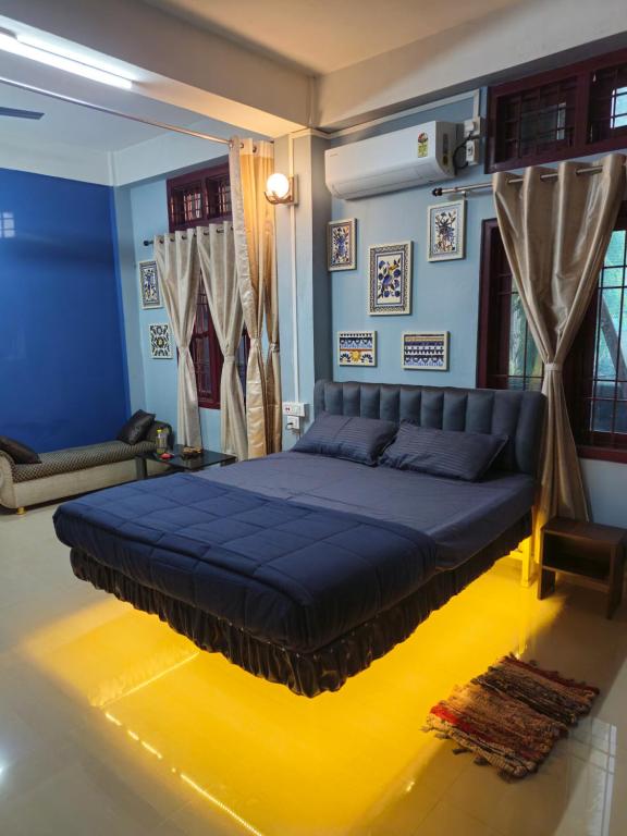 a bedroom with a large blue bed in a room at The Urban Homestay Premium Floating Bed AC Room Free Parking in Dibrugarh