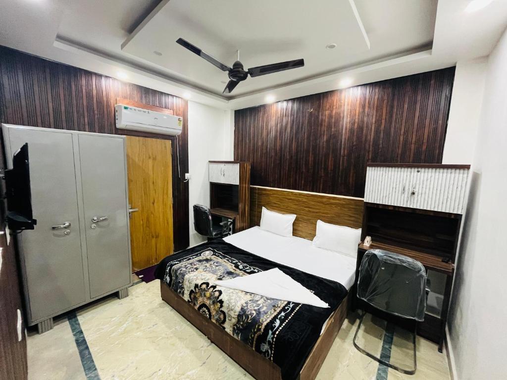 a bedroom with a bed and a tv in it at Laxmi Inn Guest House in New Delhi