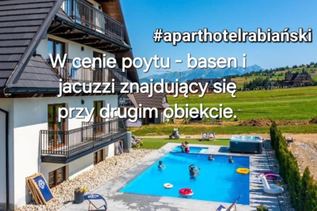 a swimming pool in the backyard of a house at Apartamenty Borysek De Lux in Białka Tatrzanska