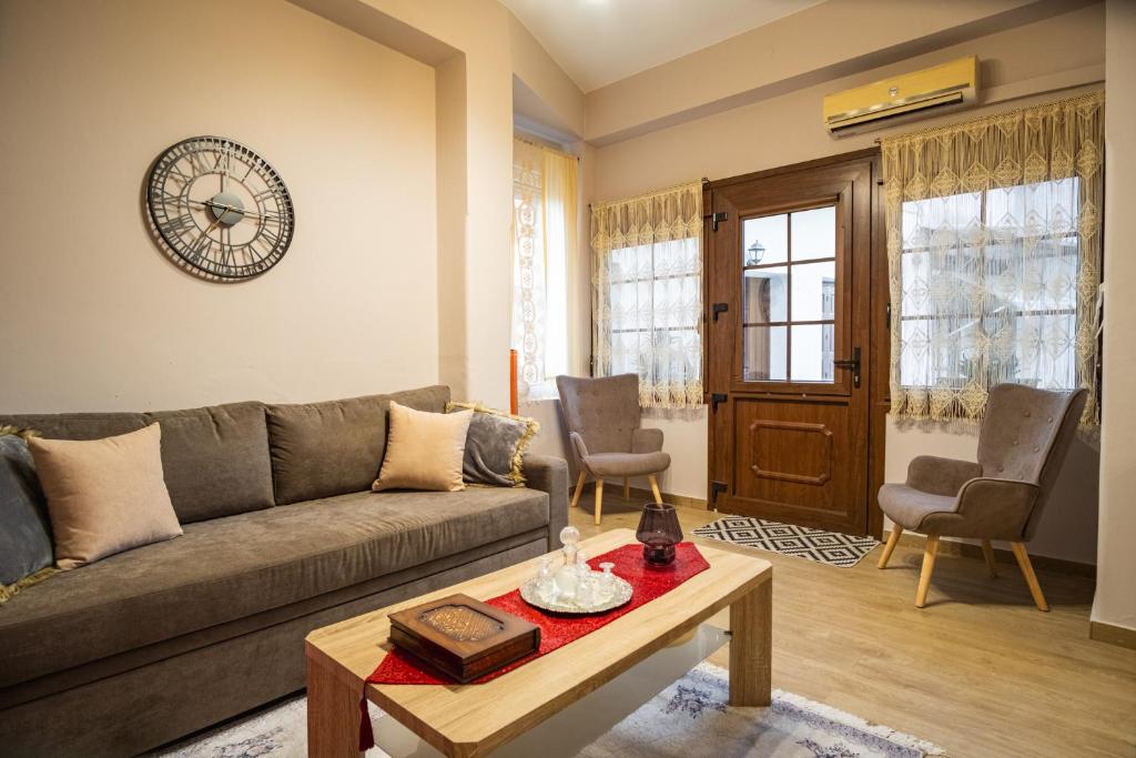 a living room with a couch and a table at Mary's cozy apartments in Pýrgos