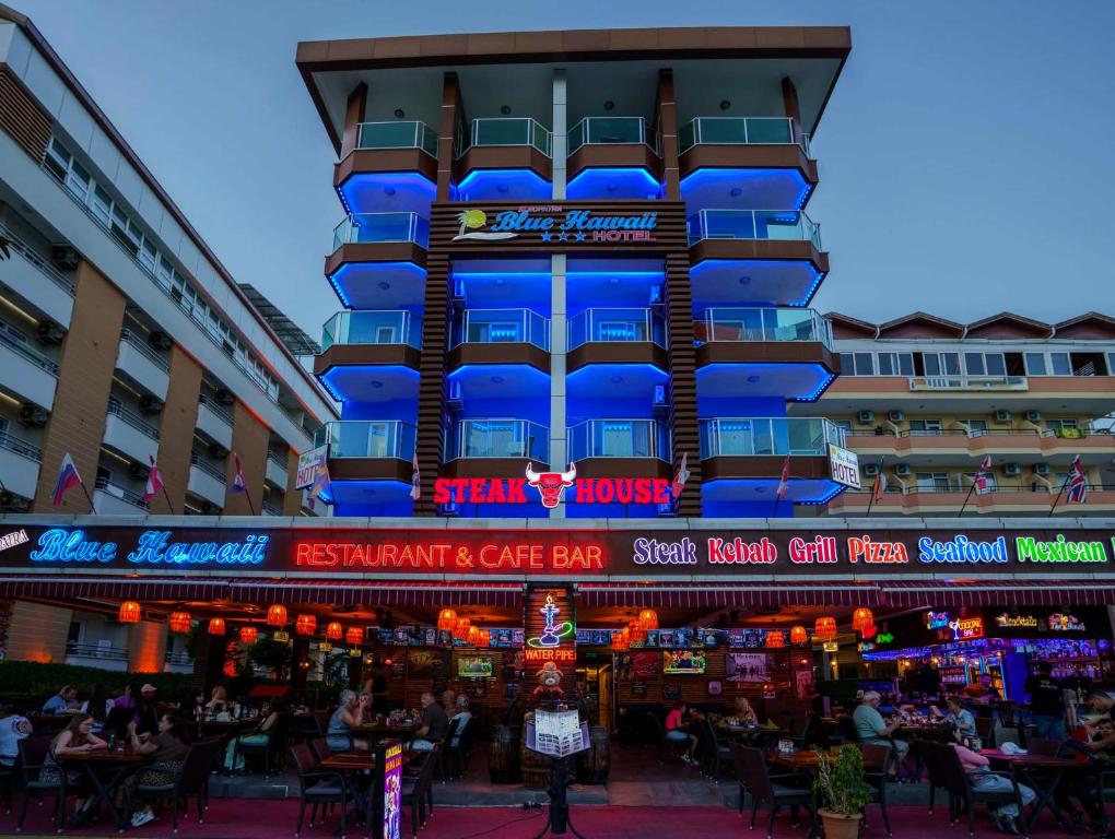 a building with blue lights on the side of it at Kleopatra blue hawai hotel in Alanya