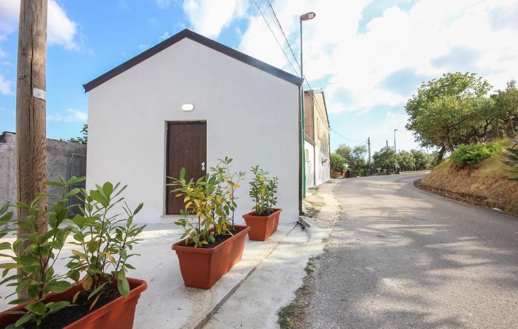 a white building with plants on the side of a street at Gorgeous Home In Casalvelino With Wifi in Casal Velino