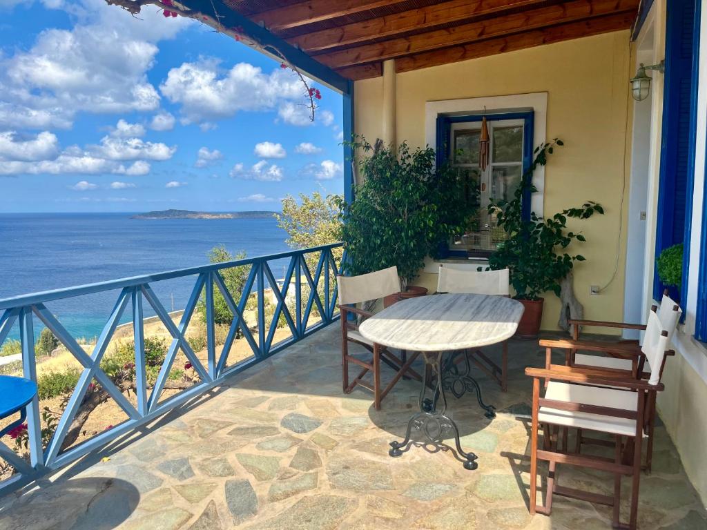 a balcony with a table and a view of the ocean at Villa Natasa in Batsi