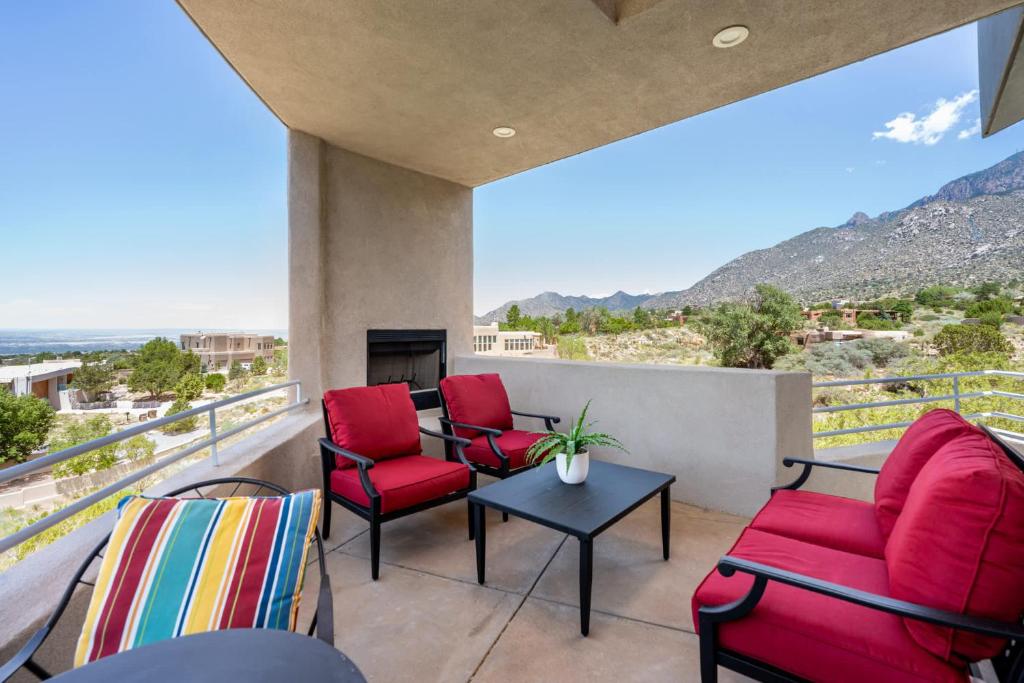 a balcony with chairs and a table with a view at Luxury 4BR Retreat with Mountain views in Sandia Park