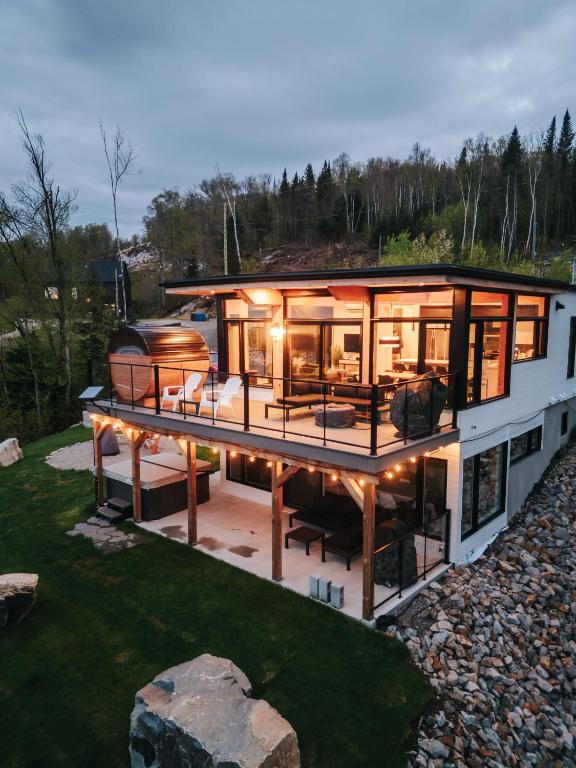 a house with a large deck with a boat on it at Ski Chalet with Spa - Mountain - La Boheme in Saint Come