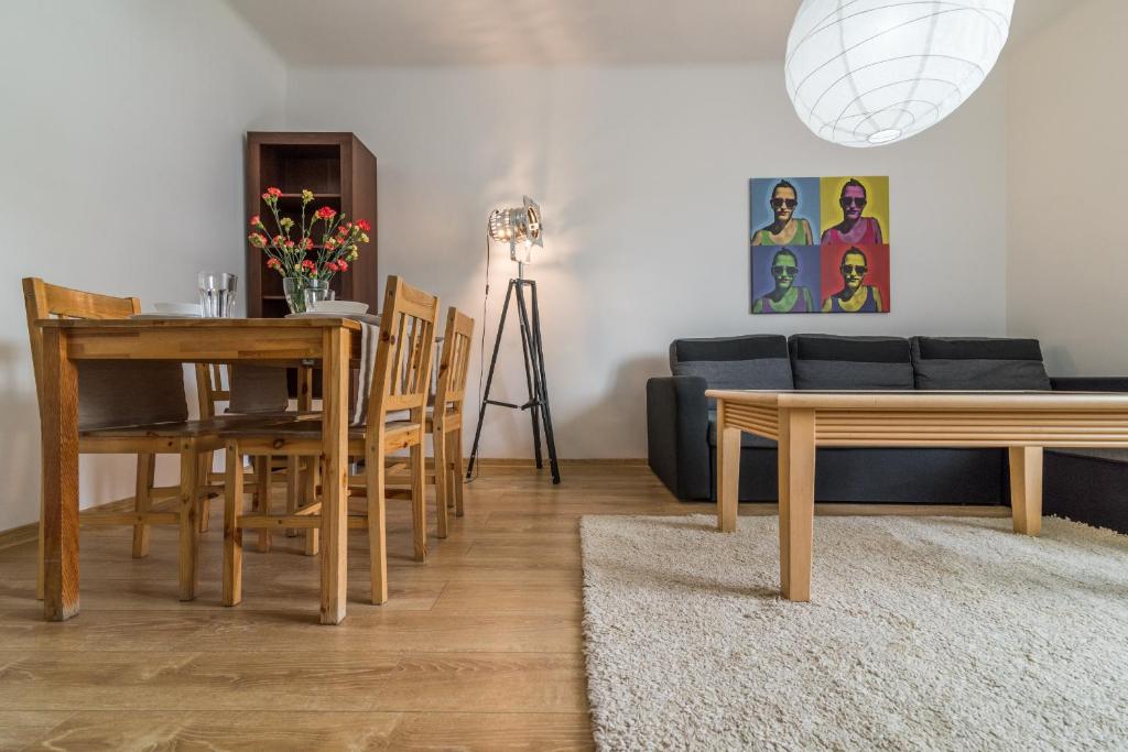 a living room with a couch and a table and chairs at Apartament Ku Słońcu - Hel in Hel