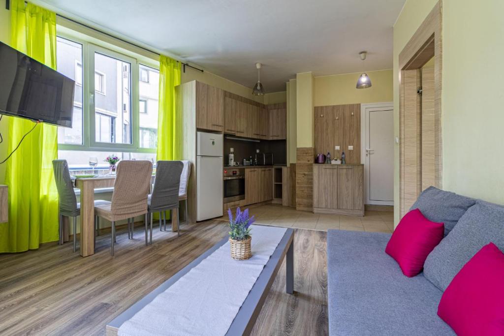 a living room with a couch and a table at My Space Deluxe One Bedroom Apartment in Sofia