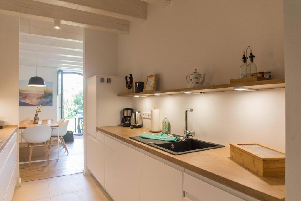 a kitchen with a sink and a counter top at Van Senden 8 Elsje in Krummhörn