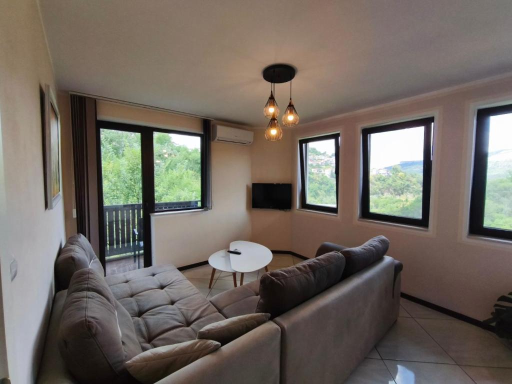 a living room with a couch and a table at Royal Apartment-Veliko Tarnovo in Veliko Tŭrnovo