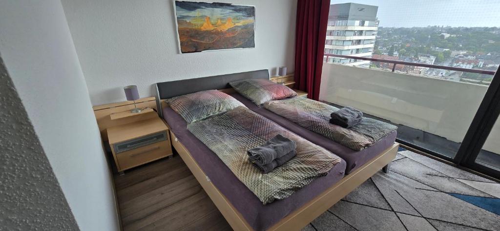 a bedroom with two beds and a balcony at Let's RelaxX 2-Rooms Free Parking in Mülheim an der Ruhr