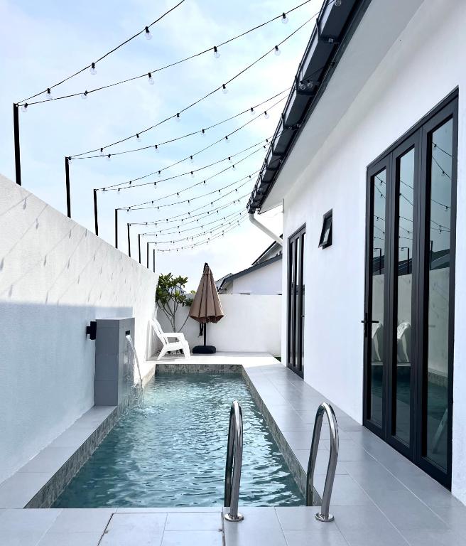 a swimming pool in the middle of a house at The Noice Villa Private pool in Kuantan