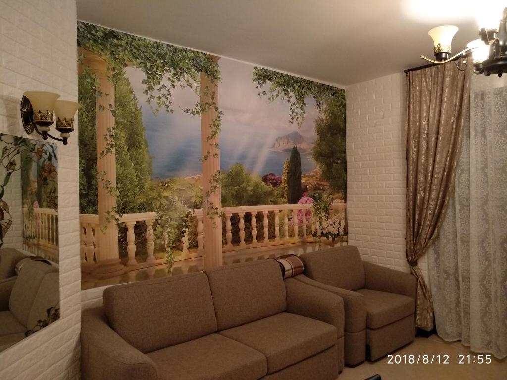 ロゼネッツにあるЭлитные апартаменты у моряのソファと壁に絵が飾られたリビングルーム