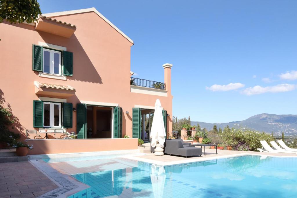 a villa with a swimming pool and a house at Casa T with landscape views in Kontokali