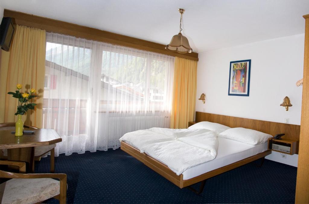 Postel nebo postele na pokoji v ubytování Hotel Alpha