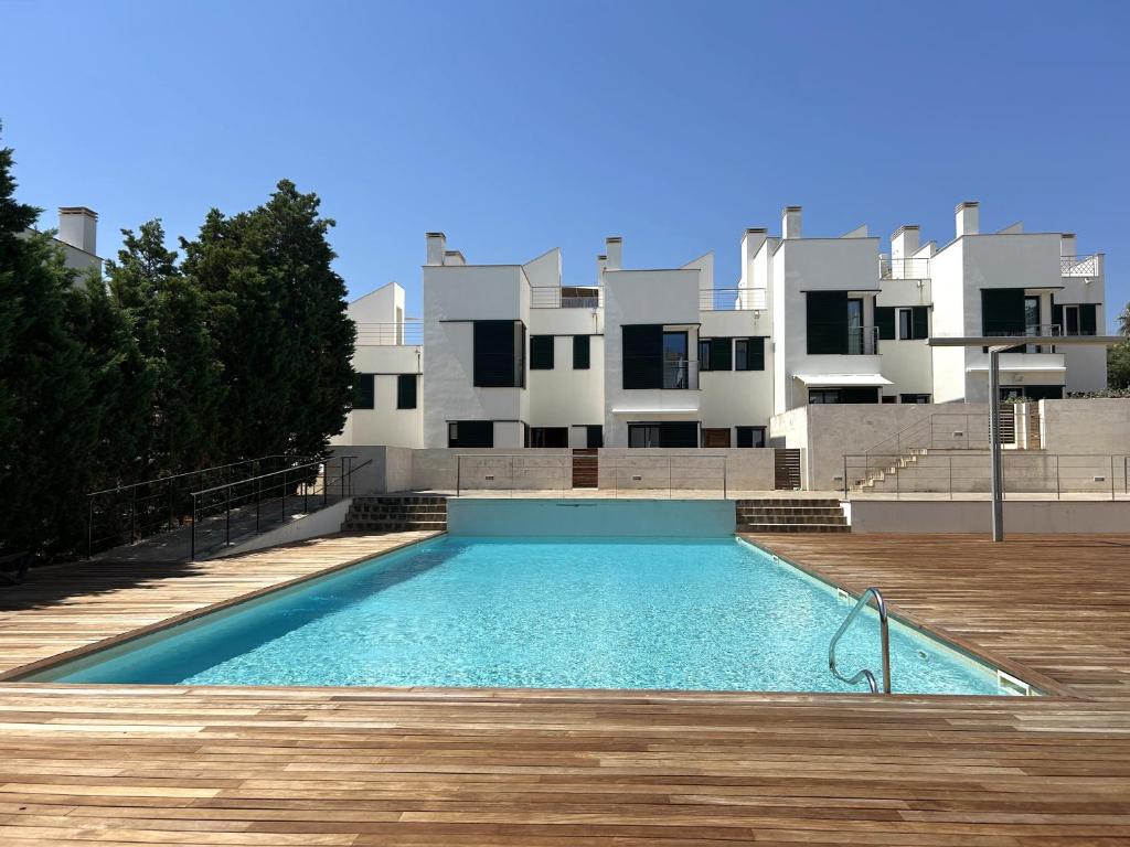 a swimming pool in front of a building at MARINA 24 by SOM Menorca in Fornells