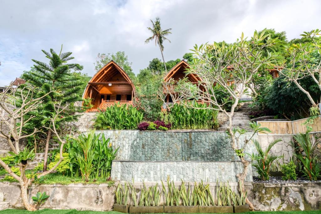 a house in the middle of a garden with trees at Adinata Villa by Manara in Seraya