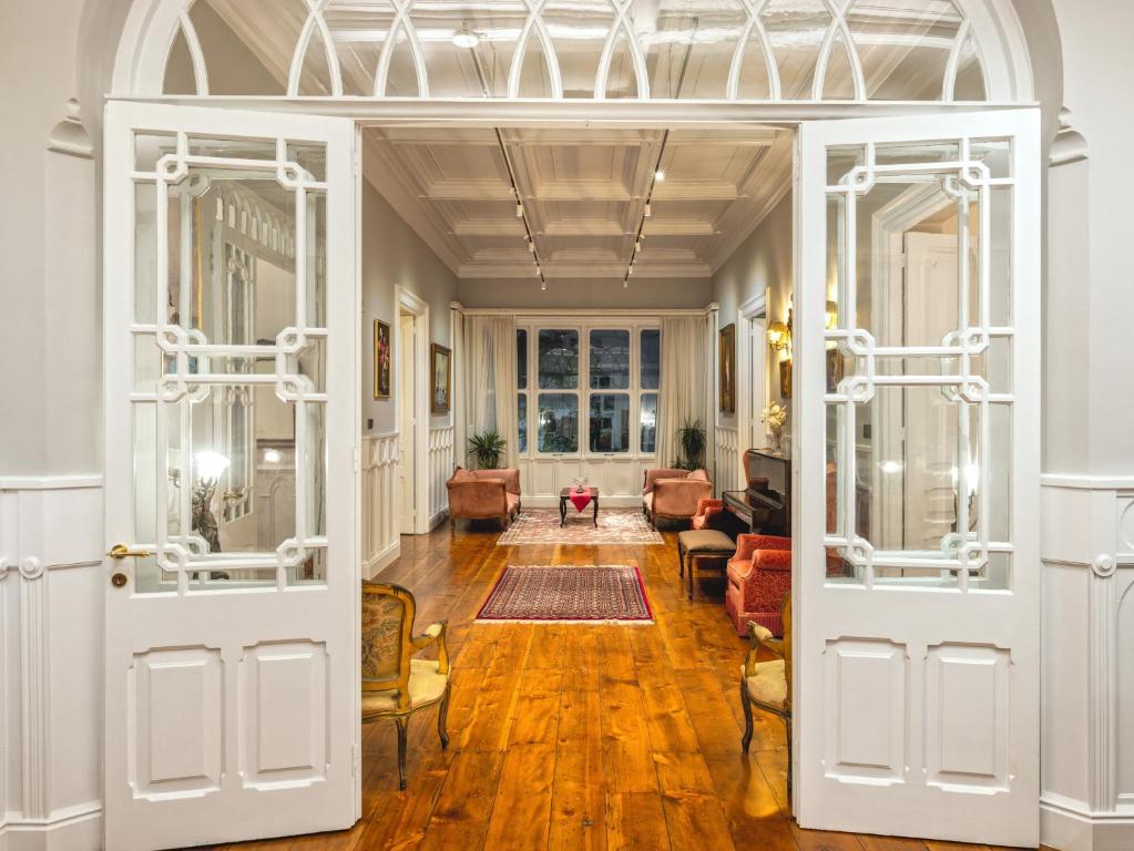 an open door into a room with a living room at Victoria Mansion A Luxurious Neoclassical Experience in Rhodes Town