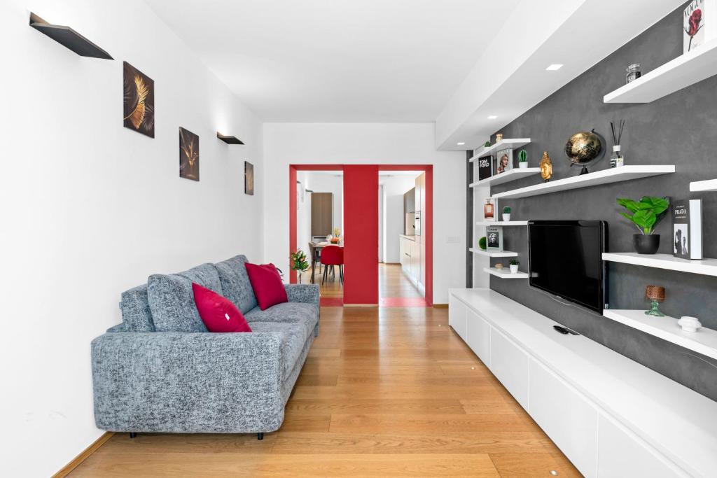 a living room with a couch and a tv at Luxury Brera apartment - Corso Como 9 in Milan
