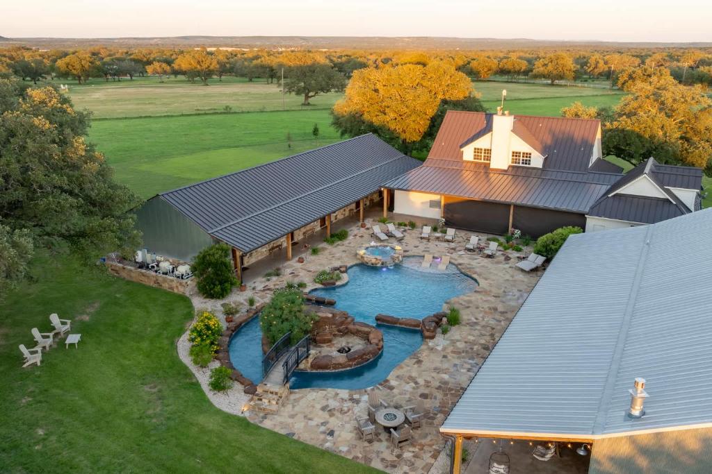 an aerial view of a house with a swimming pool at Bent Oak Highland Ranch and Concierge Services in Burnet