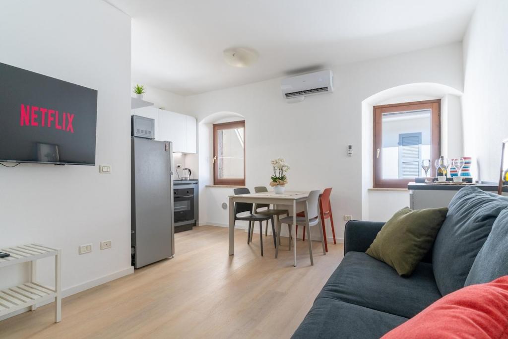 a living room with a couch and a table at Appartamenti del Borgo a 2 passi dal lago, quite in Garda