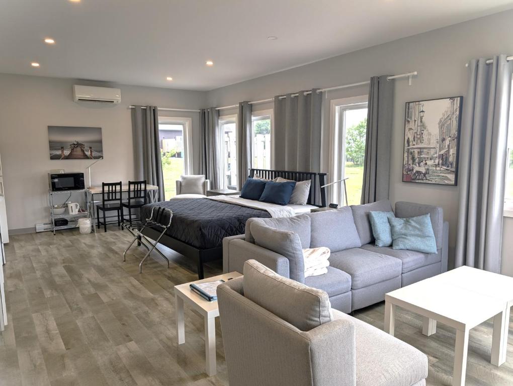 a living room with a couch and a bed at Cape Breton Flats in Inverness