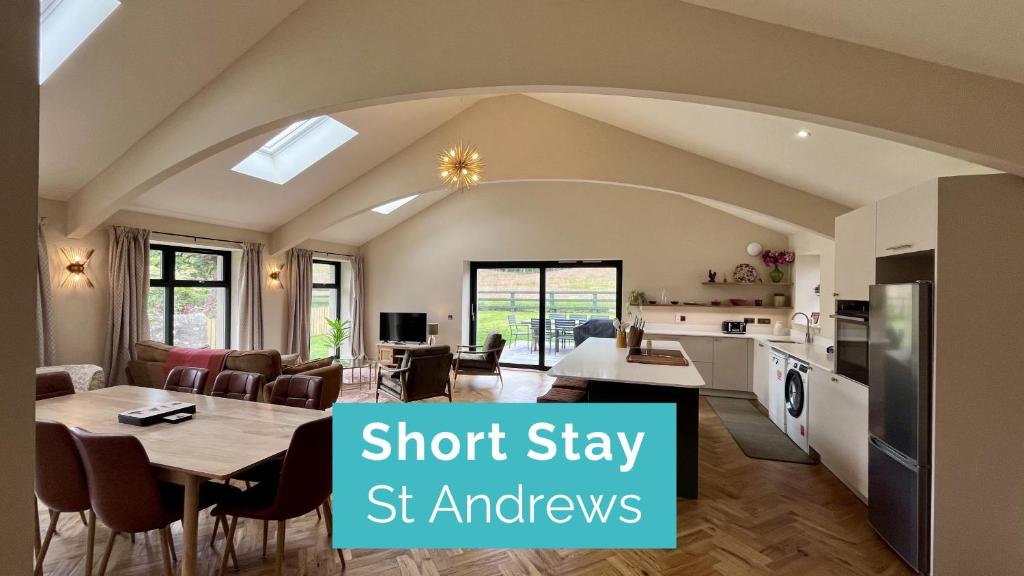 a kitchen and dining room with aoit stay st kitchens at Easter Kincaple Garden Cottage in Guard Bridge