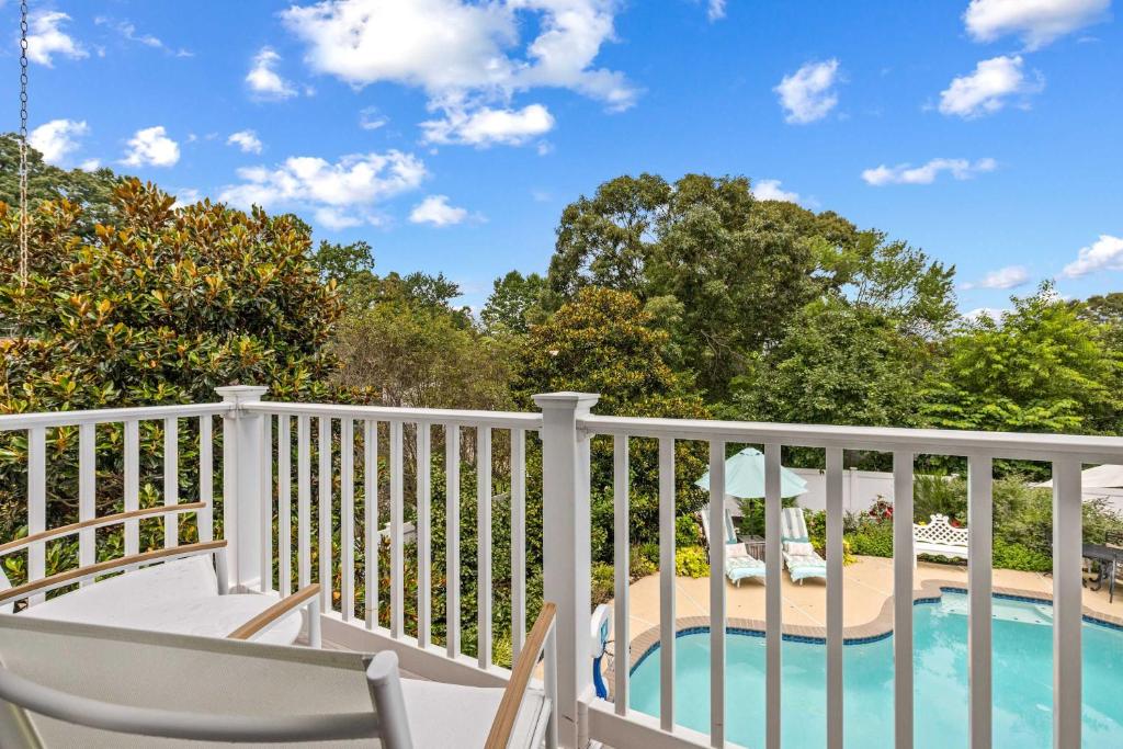 a balcony with a table and chairs and a swimming pool at The Pool Loft at Poplar Hill in Annapolis
