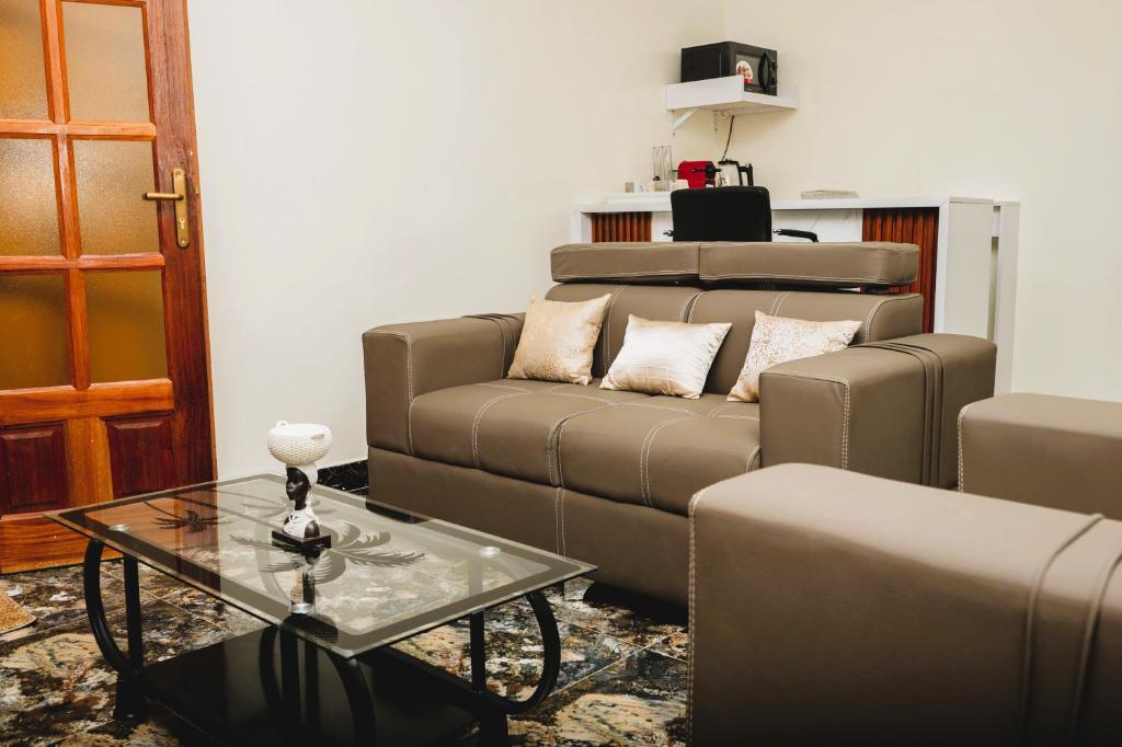 a living room with a couch and a coffee table at Senlodge in Dakar