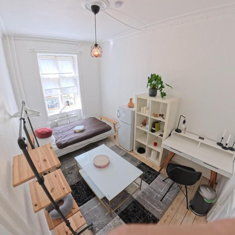 a living room with a sink and a desk at Nordhavn Cozy Room in shared apartment in Copenhagen
