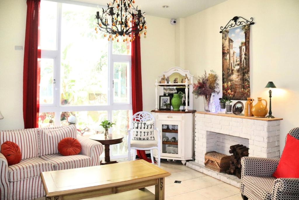 a living room with a couch and a fireplace at 城市阿瑪菲-花蓮火車站前歐風民宿 in Hualien City