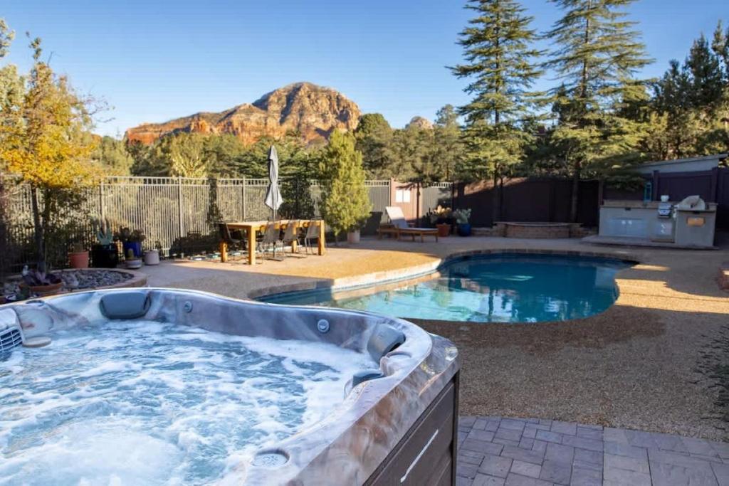 a hot tub in a yard with a mountain at Prime location with Hot tub Pool and Views for Family in Sedona
