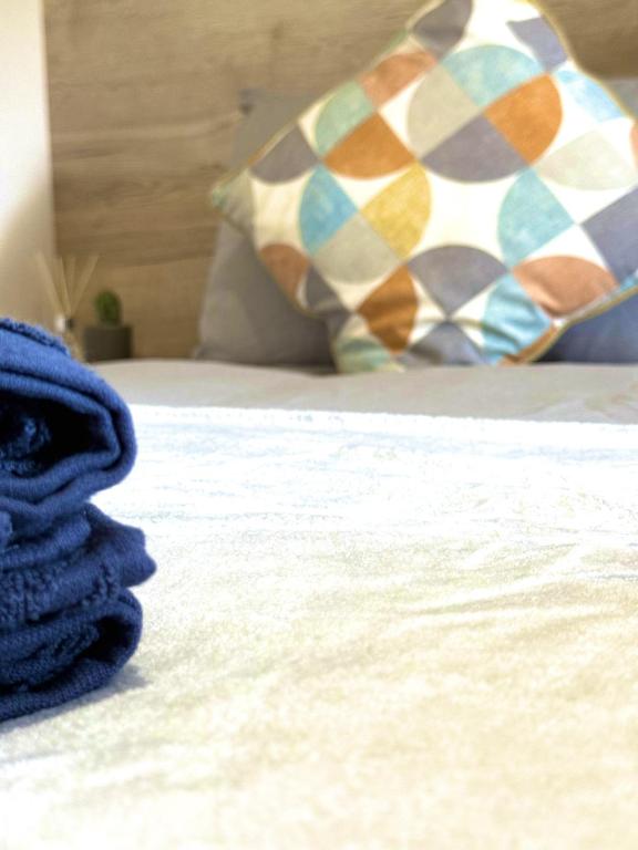 a blue towel sitting on a bed with a pillow at The Bay in Filey