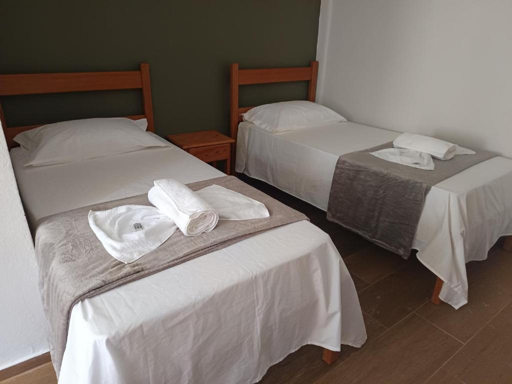ein Zimmer mit zwei Betten mit Handtüchern darauf in der Unterkunft Pousada Ebenézer de Cordeiro rj in Cordeiro