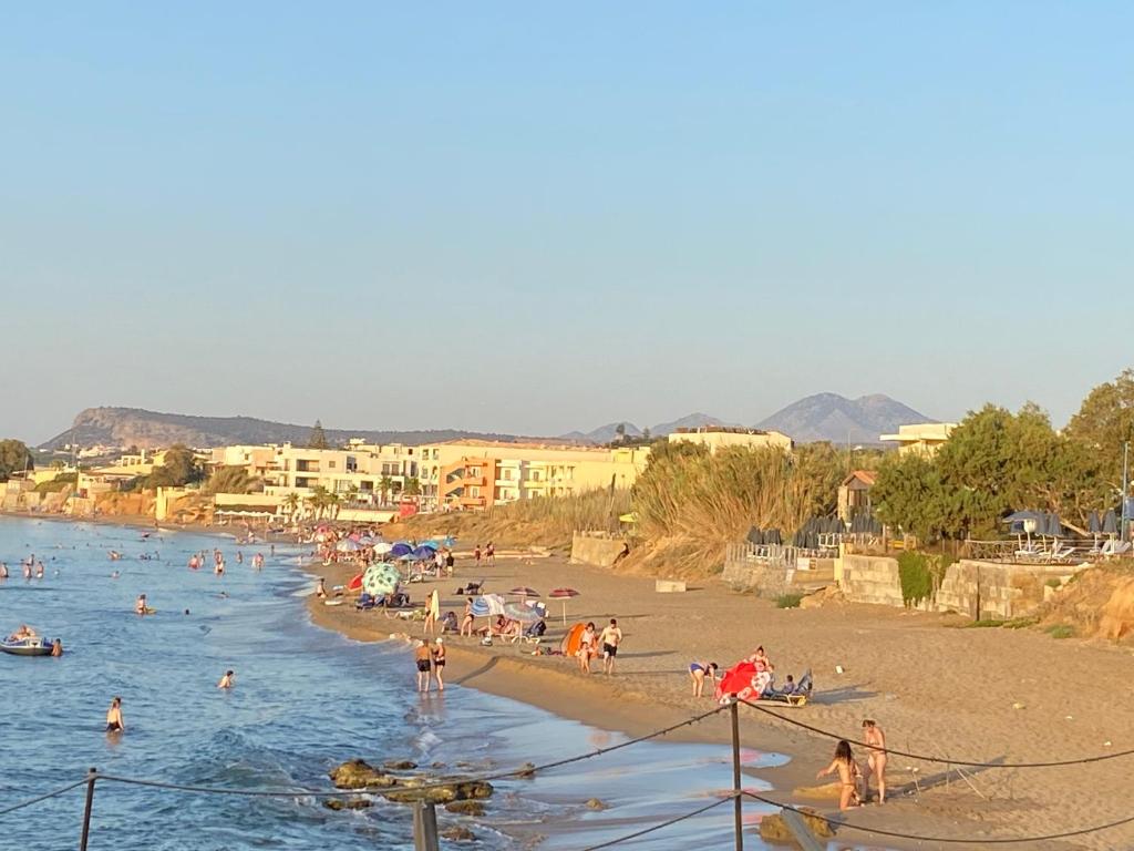 a group of people on a beach in the water at MARIA cozy apartments in Sfakaki