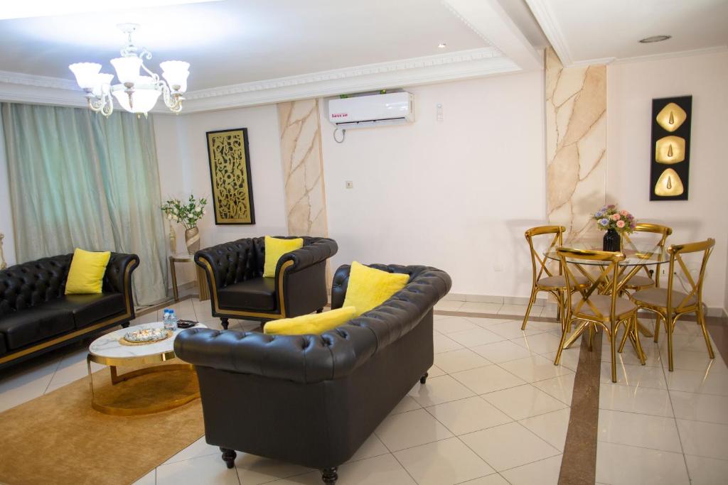 a living room with a couch and a table at Residence Le Carat in Douala