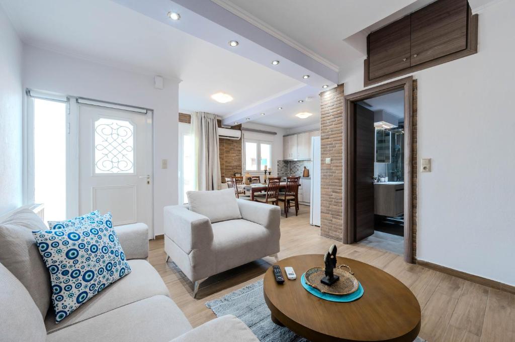 a living room with a couch and a table at Sonia's Maison in Limenas