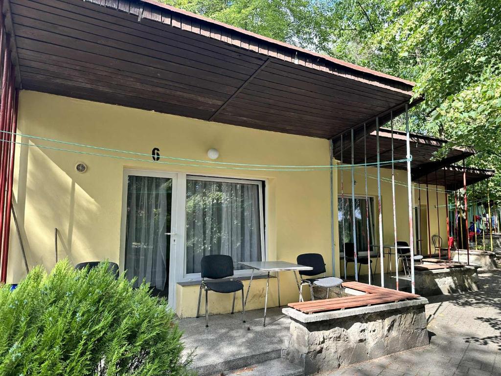 a house with a patio with a table and chairs at U Karola in Karpicko